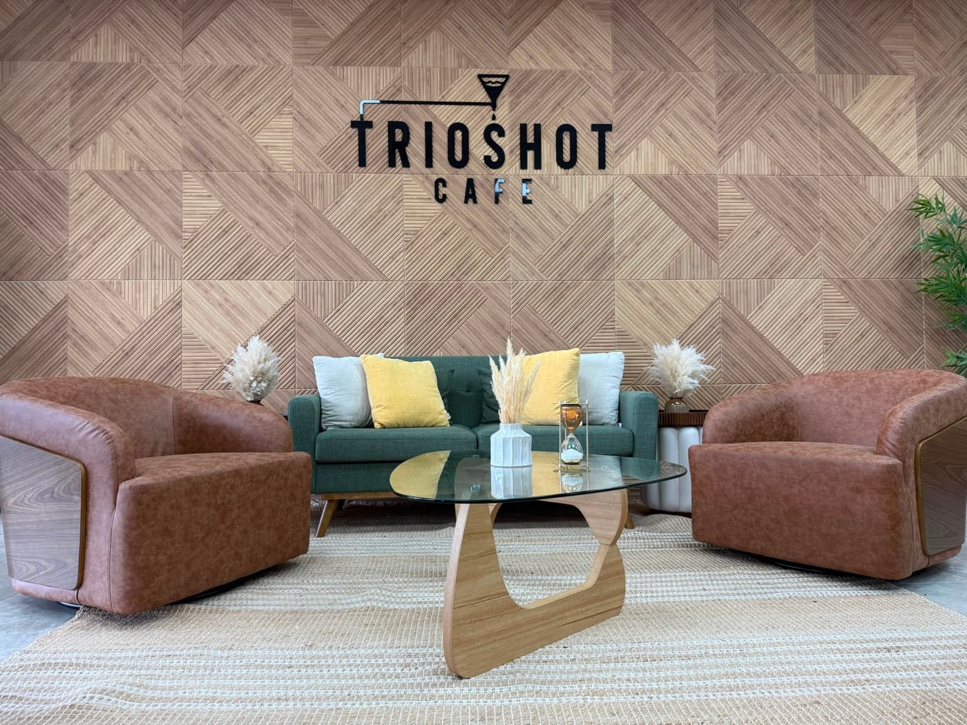 TRIOSHOT CAFE lounge with textured wall, sofa, and armchairs