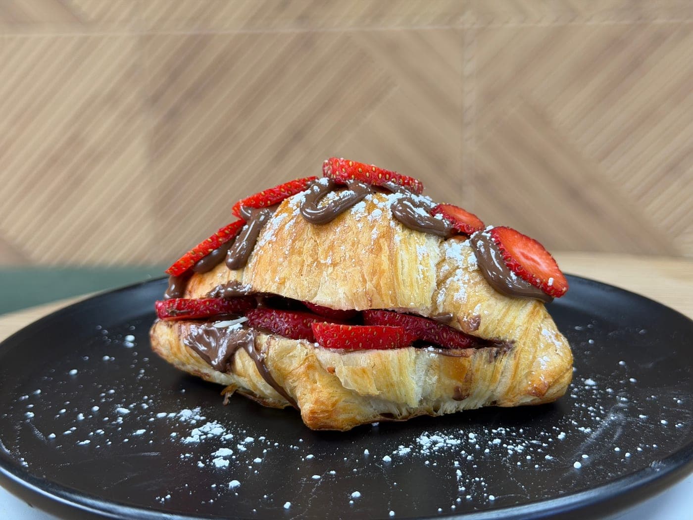 Nutella strawberry croissant on a TRIOSHOT CAFE plate