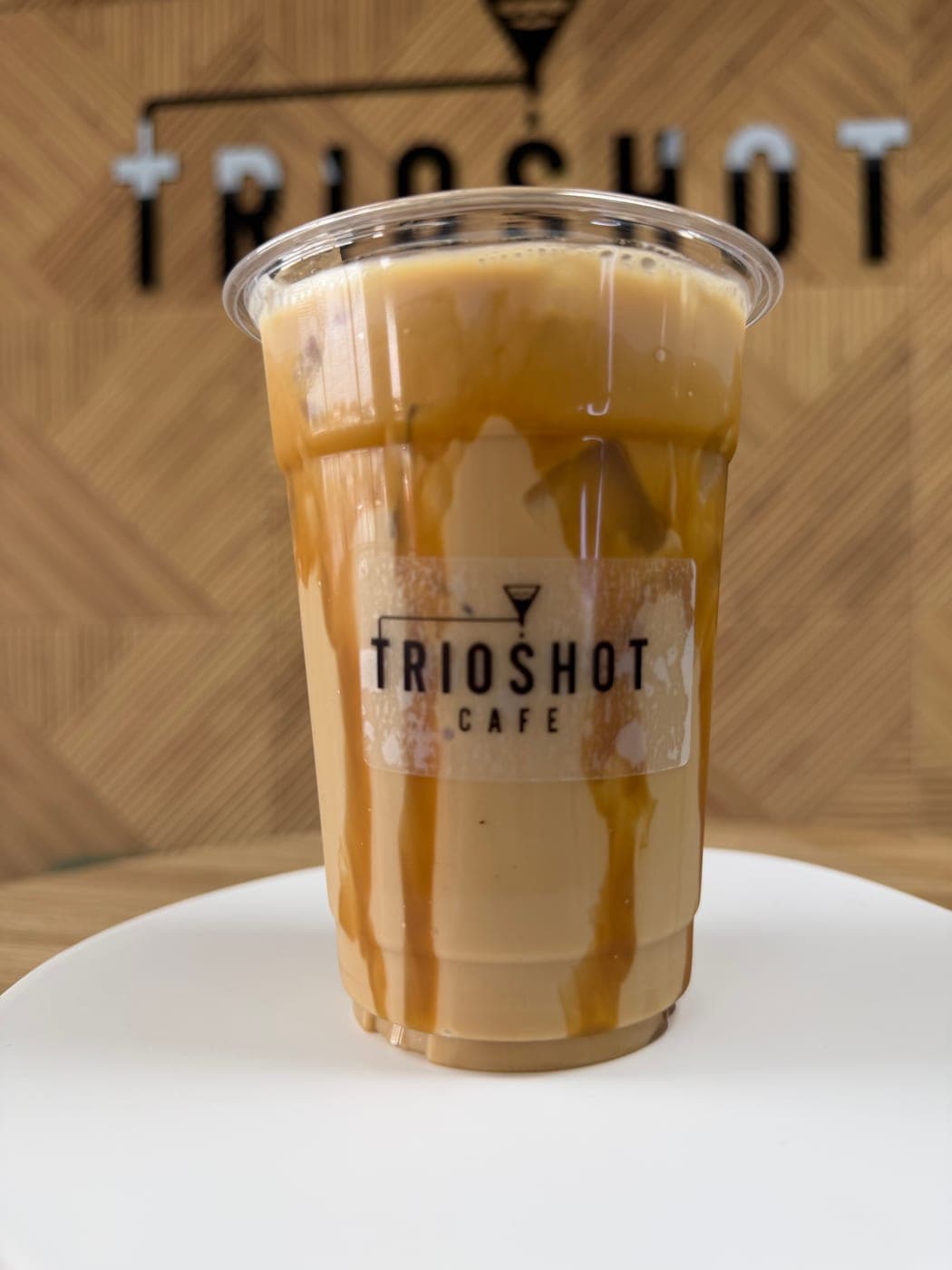 Caramel iced latte in a TRIOSHOT CAFE cup