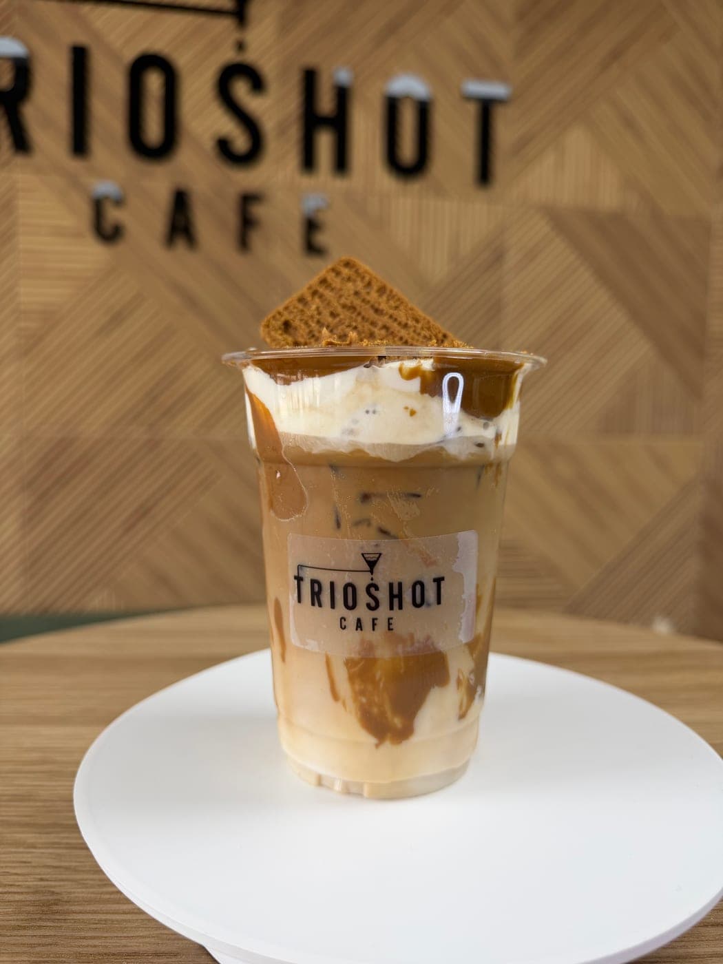 Biscoff iced latte topped with cream and a Lotus cookie